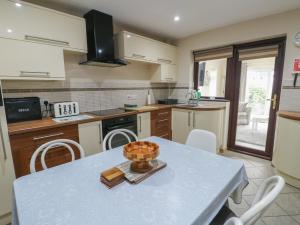 a kitchen with a table with a bowl on it at Ty Haf in Holyhead