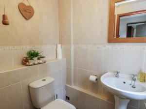 a bathroom with a toilet and a sink at Ty Haf in Holyhead +16 photos