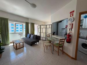 a living room with a couch and a table at Atlantic Romantic Caparica Flat in Costa da Caparica
