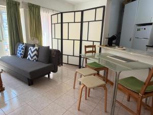 a living room with a couch and a table at Atlantic Romantic Caparica Flat in Costa da Caparica +19 photos