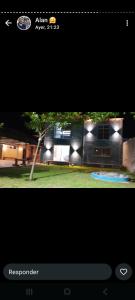 a picture of a house with lights in the yard at The Thrush in Cañuelas