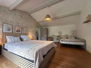 a large bedroom with a large bed and a couch at Logis de Rault in Sainte-Ouenne