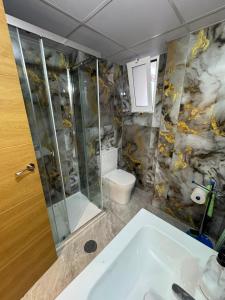 a bathroom with a sink and a shower and a toilet at Maristas in Valencia