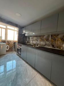a kitchen with stainless steel cabinets and a sink at Maristas in Valencia