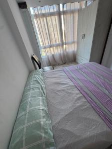 a bed in a small room with a window at Maristas in Valencia