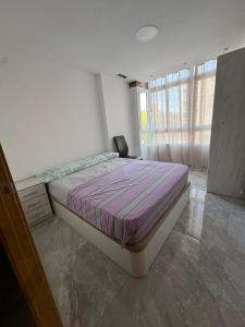 a bedroom with a bed and a chair in it at Maristas in Valencia