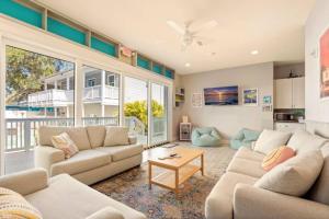 a living room with a couch and a table at Sunny Side Cottages in Dunedin