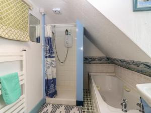 a bathroom with a bath tub and a sink at Dookers' Hoose in Buckie +24 photos
