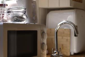 a microwave sitting on a kitchen counter next to a sink at The Beeches in Scarisbrick