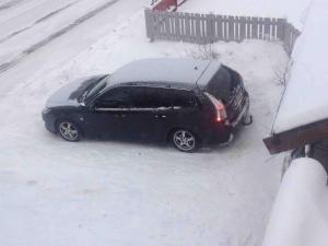 a black car parked in the snow at Apparent with 2 bedrooms for rent in Kirkenes