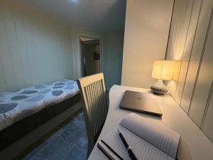 a room with a desk with a laptop and a bed at Apparent with 2 bedrooms for rent in Kirkenes