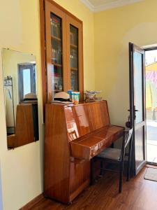 an old wooden desk in a room with a window at Light in August in Kobuleti