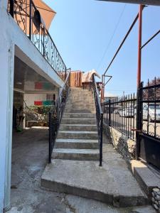 a stairway leading up to a building with a stair case at Light in August in Kobuleti +8 photos