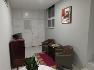 a living room with two chairs and a table at Residencia BB in Praia