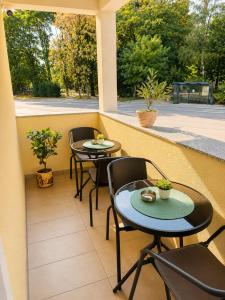 two tables and chairs on a balcony with a view at Urban Base CELJE in Celje