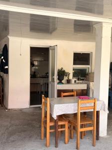 a table and chairs on a patio with a kitchen at Light in August in Kobuleti