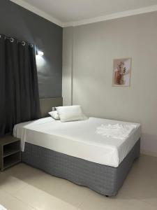 a bedroom with a large bed with white sheets at D` Garcia Hotel in Três Lagoas +37 photos
