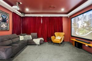 a living room with a couch and a tv at Bluewater Oasis - Stay 4 Pay 3 in Gold Coast