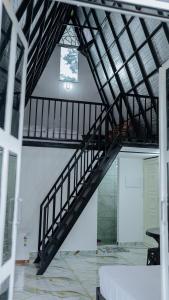a black staircase in a room with a ceiling at Sansa Villa in Athirappilly