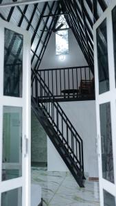 a staircase in a room with a window and a door at Sansa Villa in Athirappilly