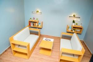 a living room with two chairs and a table at The Mimshach in Asese +3 photos