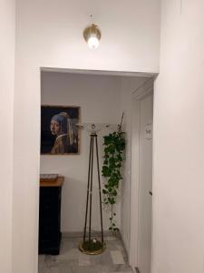 a hallway with a plant and a picture on the wall at La casa di Michelle in Foggia