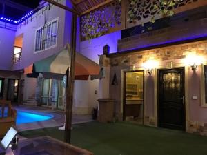a house with a swimming pool in front of it at Guest House in Luxor