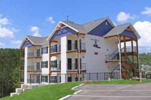 a large white apartment building with a parking lot at Stormy Point Village Lakeside in Branson