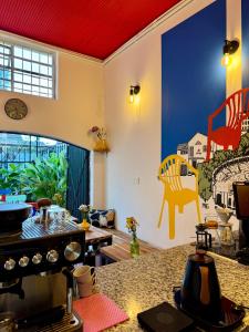 a room with a kitchen with a painting of chairs on the wall at Vecinos by La Palmera in Bogotá
