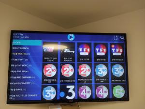 a television screen with different icons on it at Chambre d'hôte à Wiltz in Wiltz