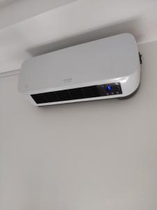 a white air conditioner hanging from a ceiling at Chambre d'hôte à Wiltz in Wiltz