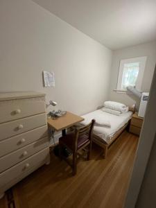 a bedroom with a bed and a desk with a table at Dunbar Home in Vancouver