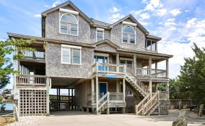 a large house with balconies and stairs at 8198 - Still Waters in Waves +88 photos