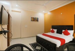 a bedroom with a bed and a flat screen tv at Elite HomeZ in Greater Noida