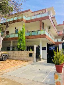 a building with a parking lot in front of it at Elite HomeZ in Greater Noida