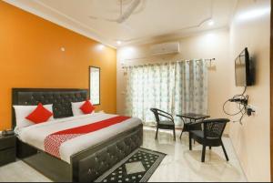 a bedroom with a bed and a dining room at Elite HomeZ in Greater Noida