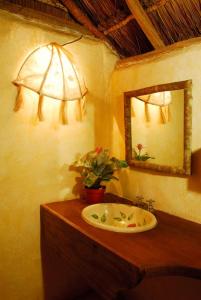 a bathroom with a sink and a mirror at Hotel Puerta Calakmul in Conhuas +9 photos