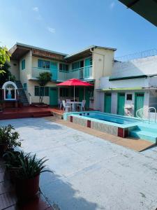 a building with a swimming pool next to a house at Casa quinta en Girardot in Girardot