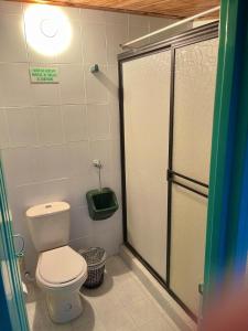 a bathroom with a toilet and a shower stall at Casa quinta en Girardot in Girardot +21 photos