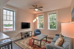 a living room with a couch and a tv at Historic King James Unit 1 in Asheville +6 photos