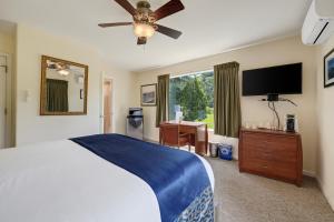 a bedroom with a bed and a flat screen tv at West Sonoma Inn & Spa in Guerneville