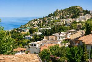 a view of a town on a hill with houses at B&B Giulia in Taormina