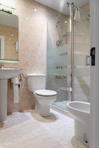 a bathroom with a toilet and a sink and a shower at Santacruz in Oviedo
