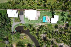 an aerial view of a resort with palm trees at Hygge Residence - Barra Grande - Península de Maraú in Marau