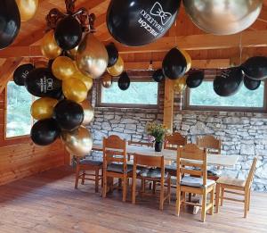 a dining room with a table and balloons at Ajurweda na Jurze Agroturystyka in Choroń