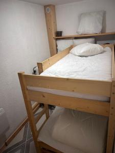 a bedroom with a bunk bed with white sheets at B&B cot in La Ferrière +2 photos