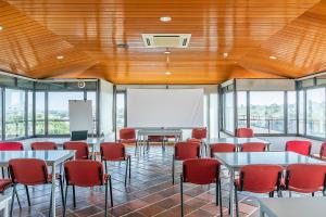 a conference room with tables and chairs and a whiteboard at HI Almada - Pousada de Juventude in Almada