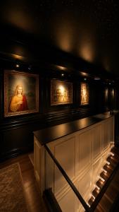 a room with a painting on the wall and a bench at Lusso Hotel in Prishtinë +34 photos