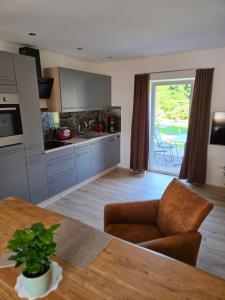 a kitchen with a table and a dining room at Am Rittergut Giesenstein Gartenblick in Bad Gottleuba