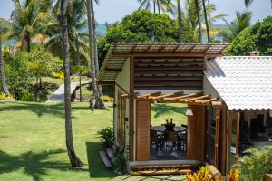 a small house with a table in the yard at Hygge Residence - Barra Grande - Península de Maraú in Marau +90 photos